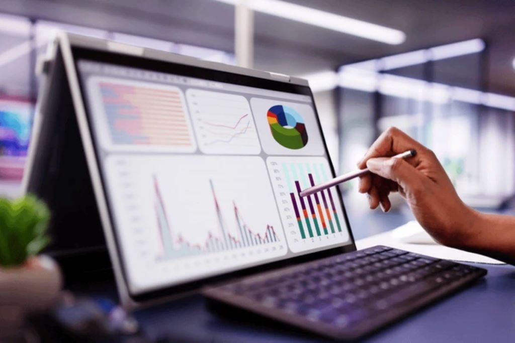 A group of professionals analyzing currency exposure data on a computer screen